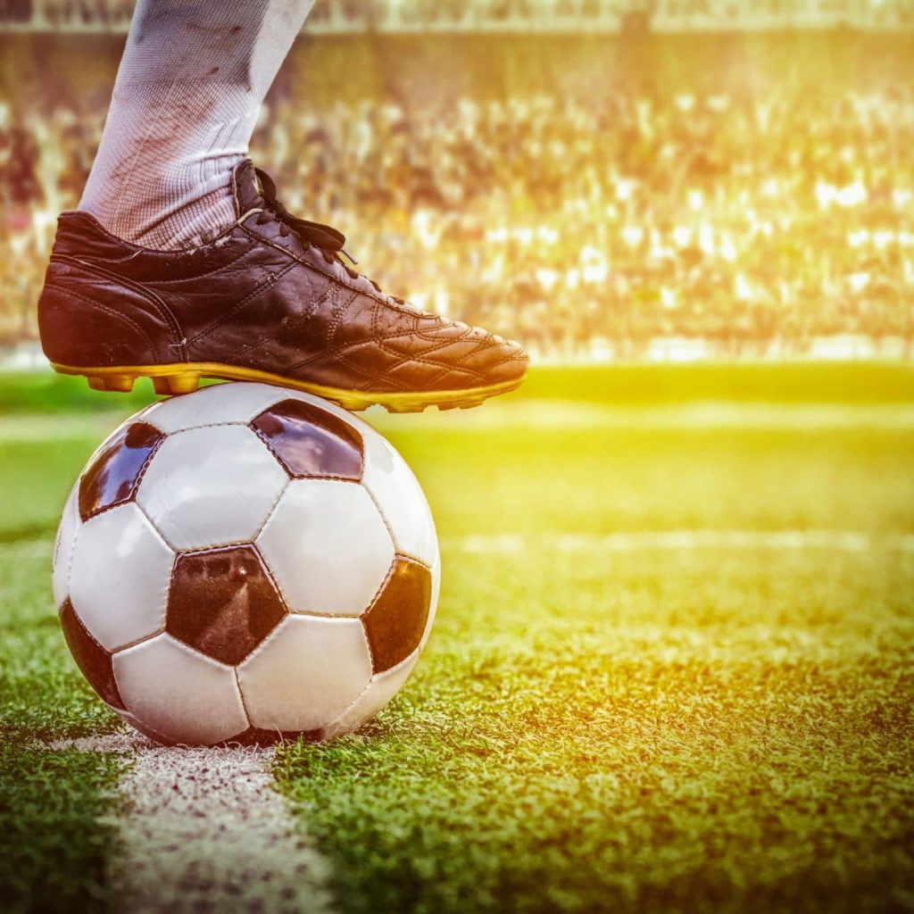 A football match with a close up of the football