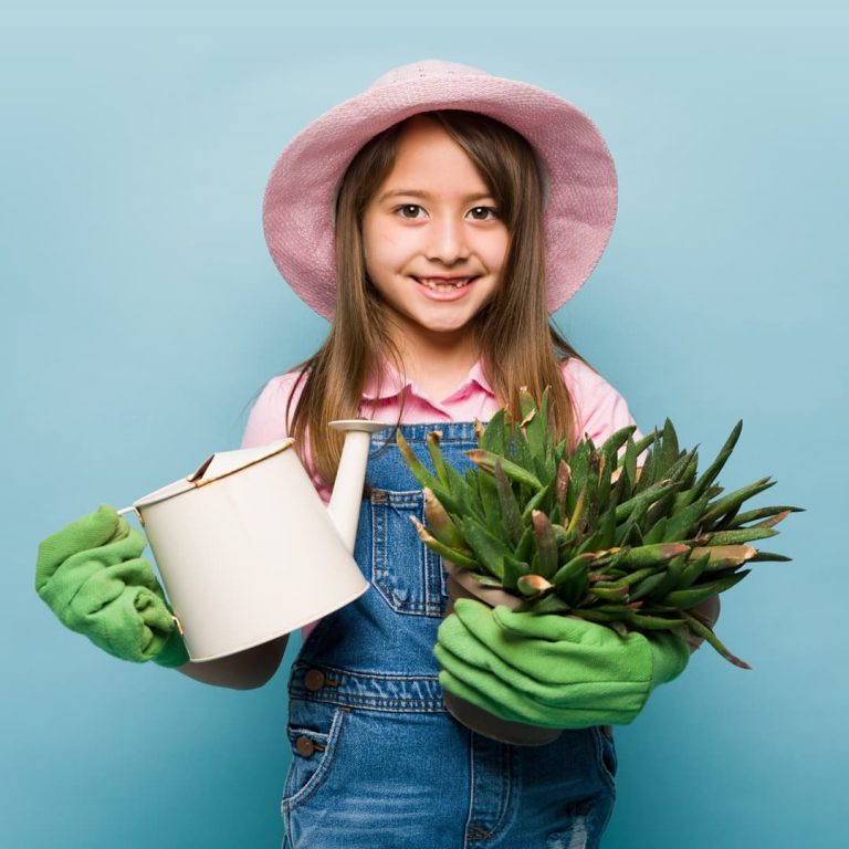 A girl holding gardening equipment for New Squares Sow & Grow event